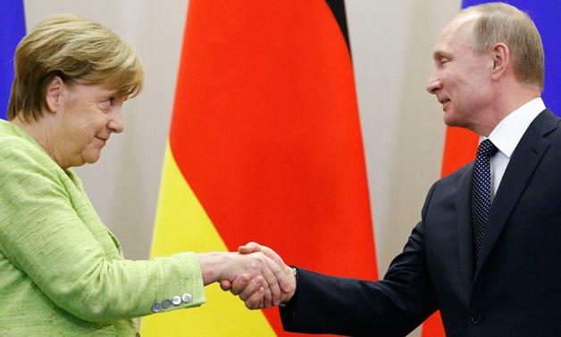 Russian President Vladimir Putin and German Chancellor Angela Merkel shake hands during a joint news conference following their talks at the Bocharov Ruchei state residence in Sochi, Russia, May 2, 2017. REUTERS/Alexander Zemlianichenko/Pool