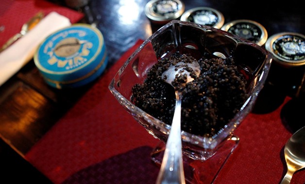 FILE PHOTO: A cup with caviar is prepared for a competition, which requires contestants to consume 500 grams of caviar in the fastest speed in Moscow, Russia April 20, 2012. REUTERS/Maxim Shemetov/File Photo
