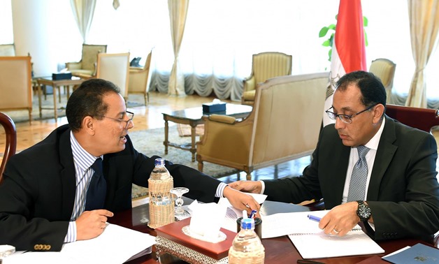 Prime Minister Mostafa Madbouli with Head of Financial Supervisory Authority (FSA) Mohamed Omran on August 25, 2018 - Press photo/Cabinet