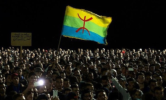 This file photo taken on October 30, 2016 shows protesters waving the Berber flag as they demonstrate in Morocco's northern city of Al-Hoceima - AFP