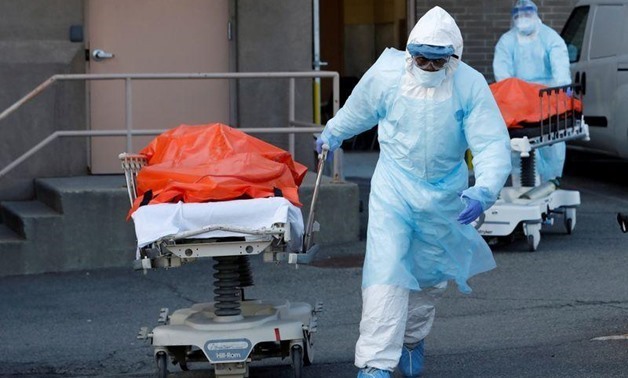 FILE - Healthcare workers wheel the bodies of deceased people from the Wyckoff Heights Medical Center during the outbreak of the coronavirus disease (COVID-19) in the Brooklyn borough of New York City, New York, U.S., April 4, 2020 – Reuters/Andrew Kelly