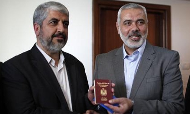 Senior Hamas leader Ismail Haniyeh (R) gives Hamas chief Khaled Meshaal a diplomatic Palestinian Authority Passport before Meshaal leaves Gaza Strip December 10, 2012. REUTERS/Ahmed Jadallah