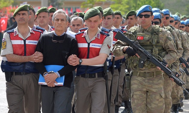 Akin Ozturk, a former Turkish Air Force commander who is accused of plotting and orchestrating last year's failed coup, is escorted - REUTERS/Stringer 