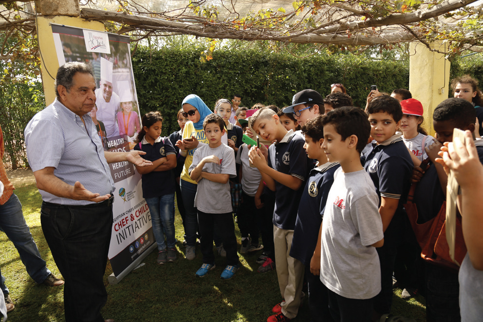 Monir Makar, the founder of Makar Farms, talks to children during the launch of the "Chef and Child" initiative, which seeks to promote healthy eating.
